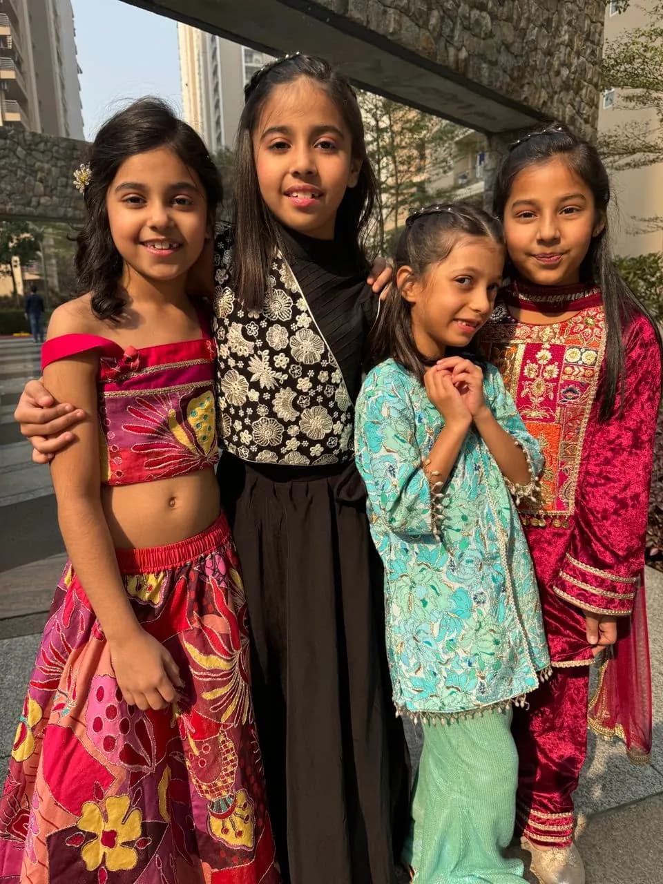 Four girls in printed festive outfits